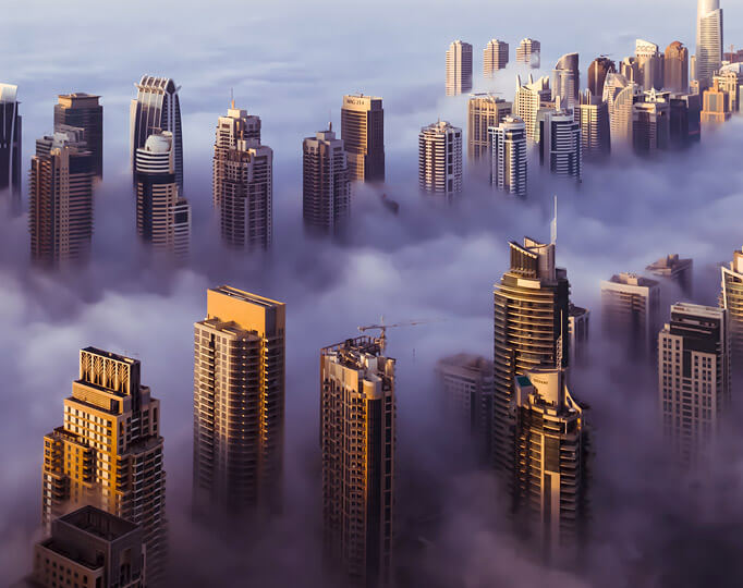 skyscrapers peaking through clouds