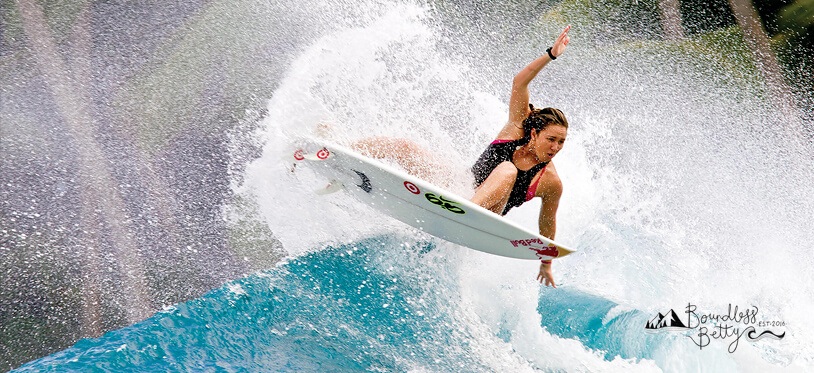 female surfer doing trick on a wave