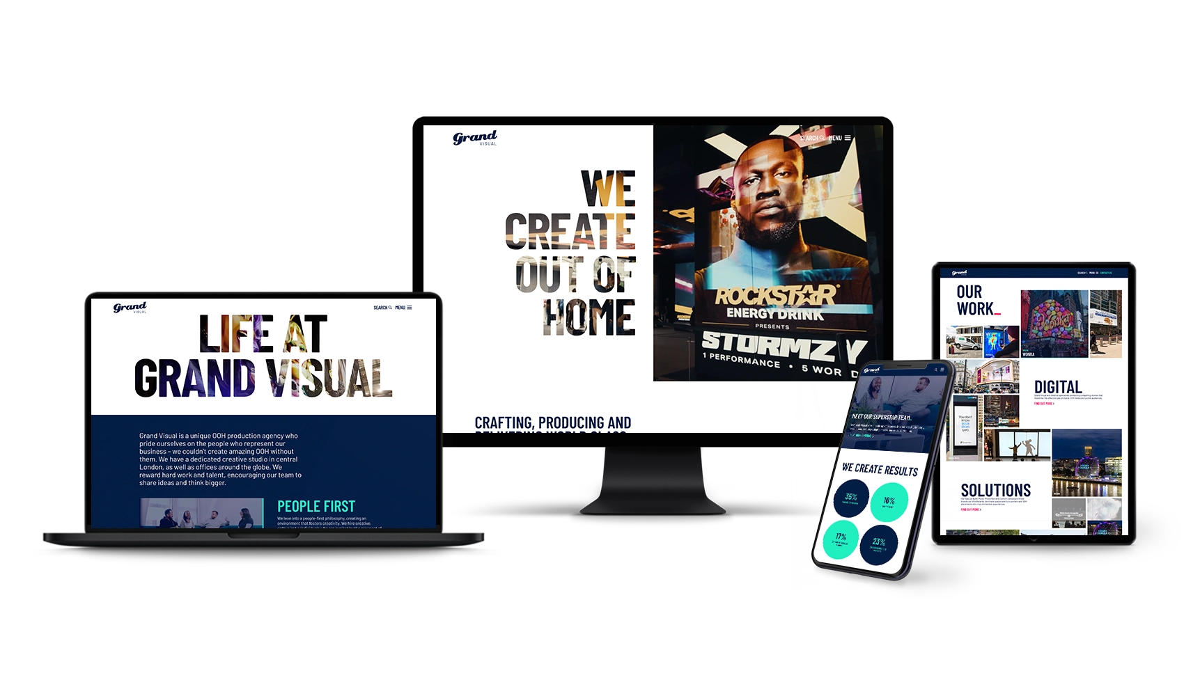 The Grand Visual website displayed across multiple devices, including a desktop monitor, laptop, tablet, and smartphone, showing bold typography and high-impact campaign imagery.